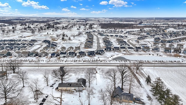 snowy aerial view featuring a residential view
