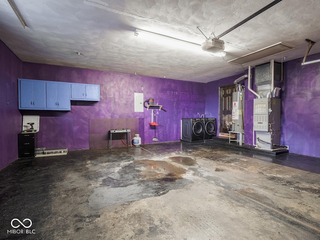 garage featuring a garage door opener, water heater, electric panel, heating unit, and washer and dryer