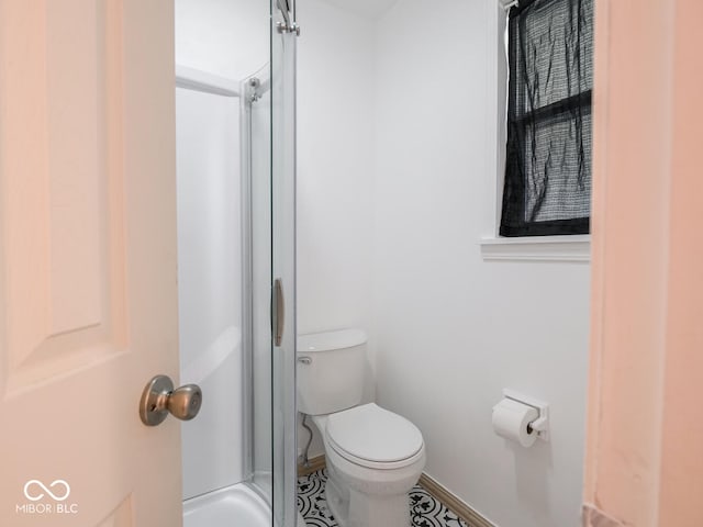 bathroom with walk in shower and toilet