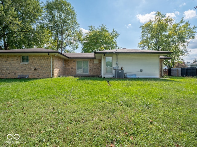 rear view of property featuring a yard