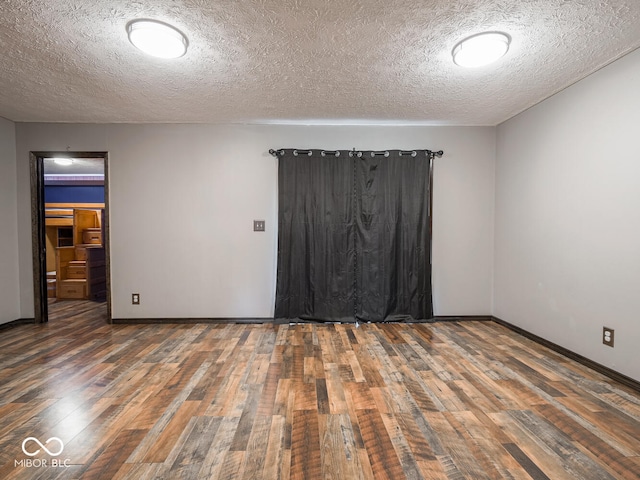 empty room with dark hardwood / wood-style flooring