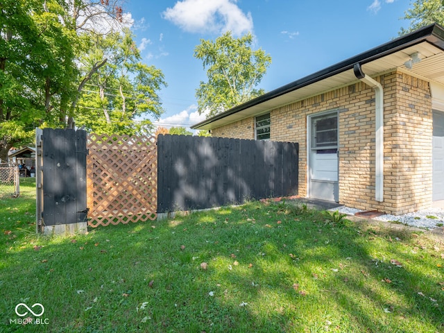 view of home's exterior with a garage and a lawn