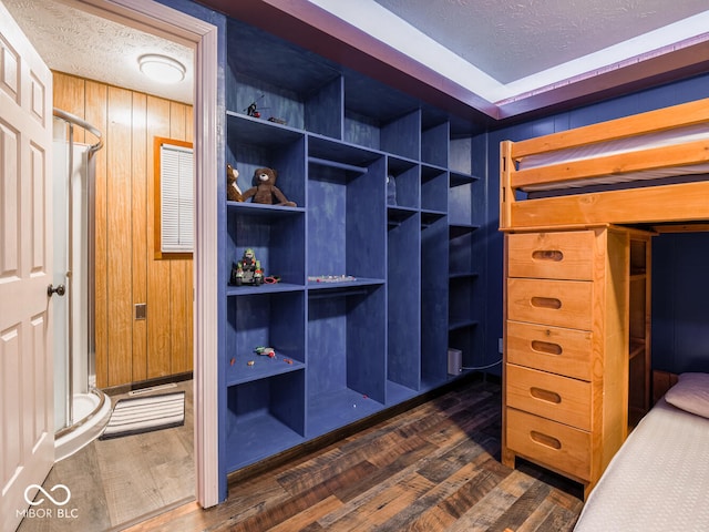 spacious closet with dark wood-type flooring