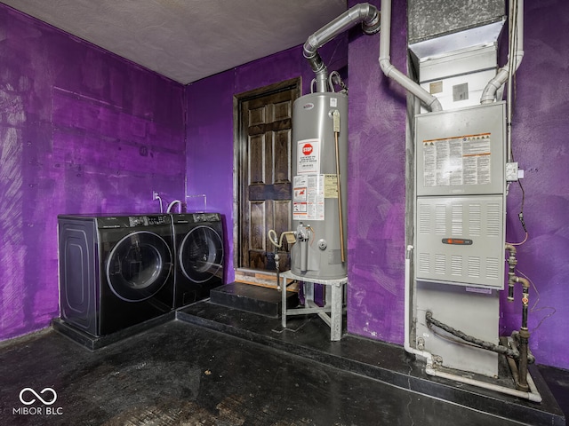 laundry room featuring washing machine and clothes dryer and water heater