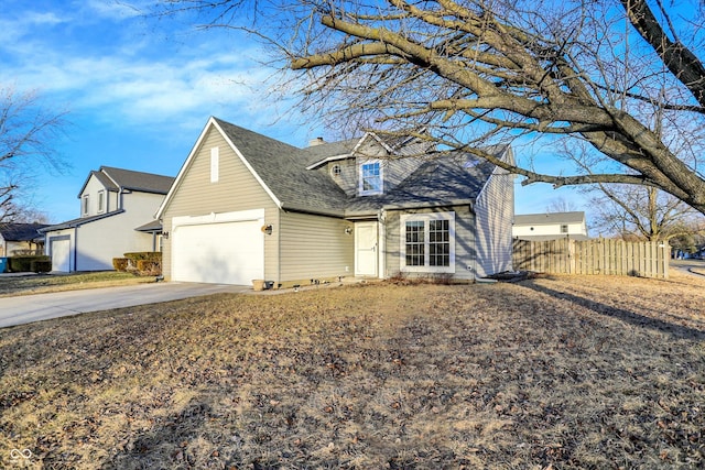 view of front of property with a chimney, a shingled roof, an attached garage, fence, and driveway