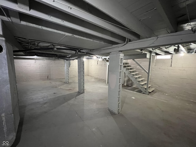 unfinished basement featuring stairway