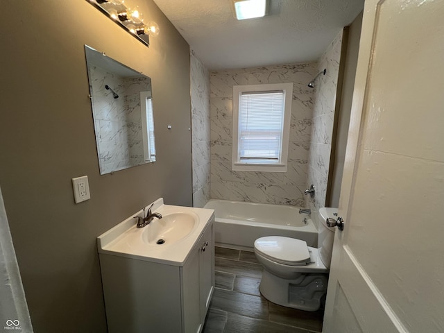 bathroom with toilet, shower / tub combination, vanity, wood finished floors, and a textured ceiling