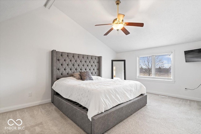 bedroom with a ceiling fan, carpet, vaulted ceiling with beams, and baseboards