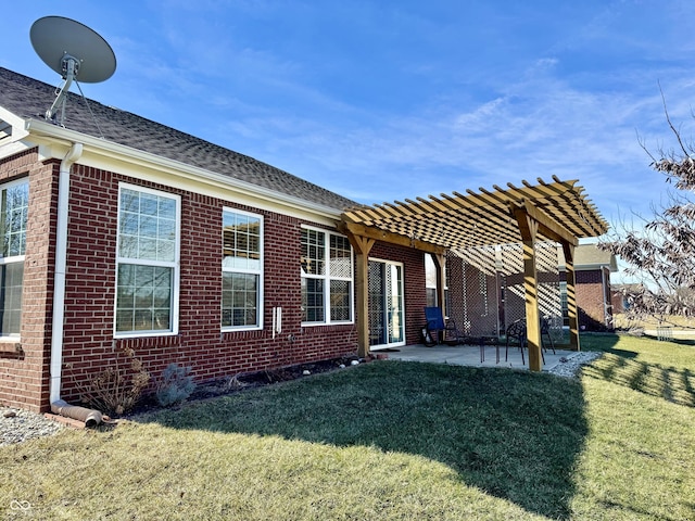 back of property with a patio, a lawn, and a pergola