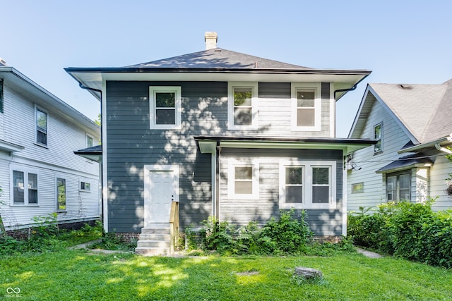 3543 N Kenwood Ave, Indianapolis, IN 46208 - rear view of house with a chimney, a yard, and entry steps