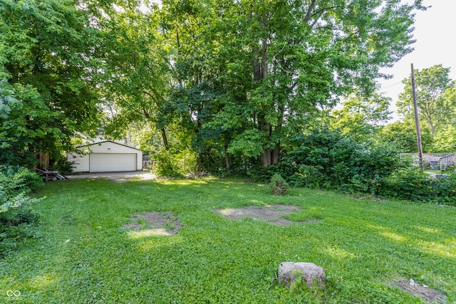 3543 N Kenwood Ave, Indianapolis, IN 46208 - view of green lawn with an outdoor structure and a garage