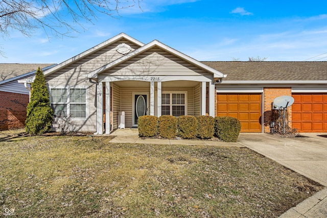 view of front facade featuring concrete driveway, roof with shingles, an attached garage, a front lawn, and brick siding