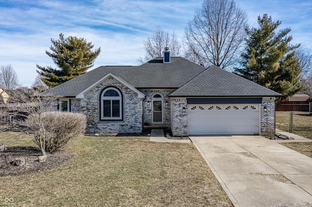 view of front of property featuring a garage and a front lawn