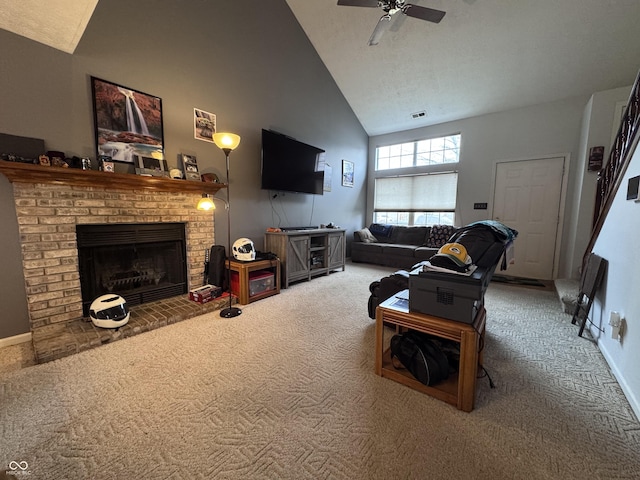 carpeted living area with baseboards, a brick fireplace, visible vents, high vaulted ceiling, and ceiling fan