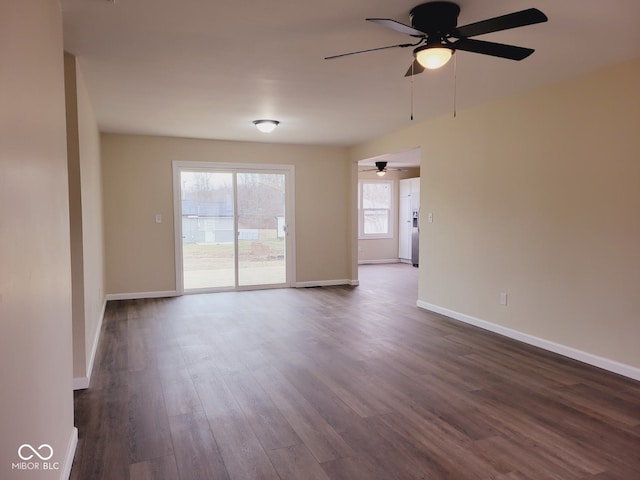 spare room featuring dark wood-style floors and baseboards