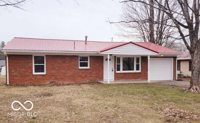 ranch-style house featuring a garage and a front yard