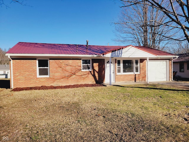 exterior space with metal roof, brick siding, a lawn, and an attached garage