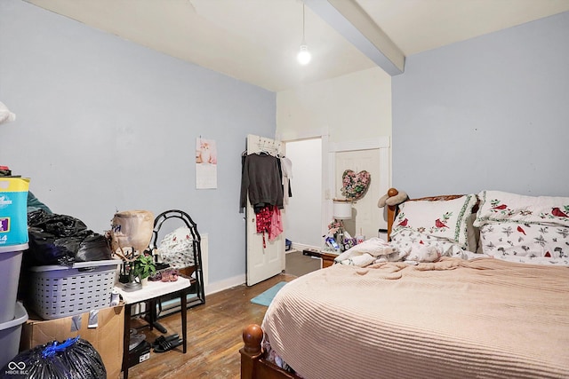 bedroom featuring beam ceiling and wood-type flooring