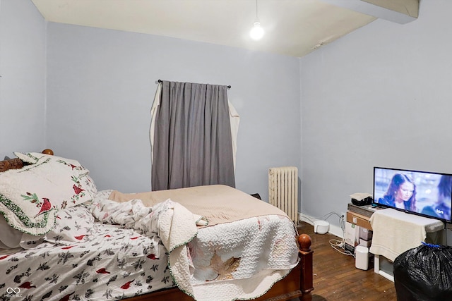 bedroom featuring dark wood-type flooring and radiator heating unit