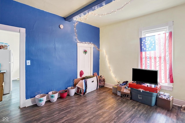 game room featuring beamed ceiling, plenty of natural light, and dark hardwood / wood-style floors