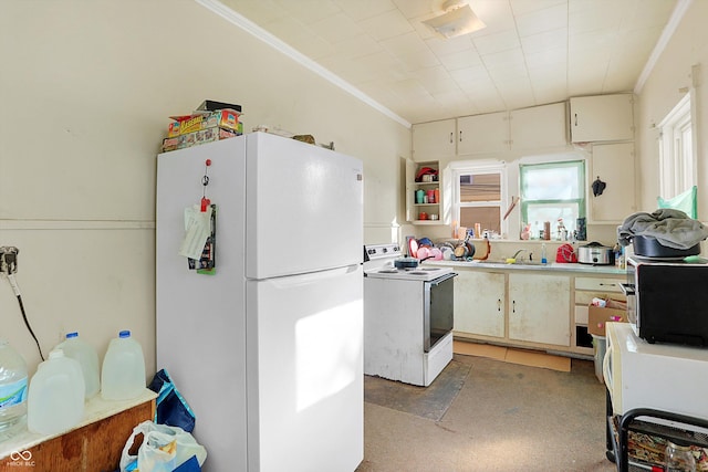 kitchen with white appliances, ornamental molding, and sink