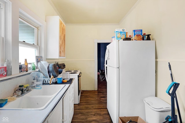 kitchen with sink, crown molding, dark hardwood / wood-style flooring, white appliances, and white cabinets