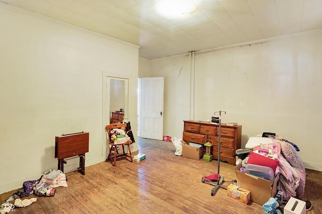 interior space with ornamental molding and hardwood / wood-style floors