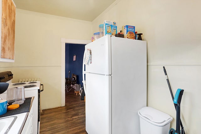 kitchen with crown molding, white appliances, dark wood-type flooring, and white cabinets