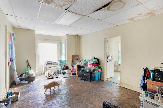 interior space featuring a drop ceiling and washer / dryer