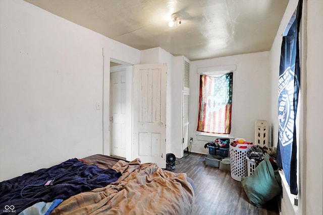 bedroom with dark hardwood / wood-style floors