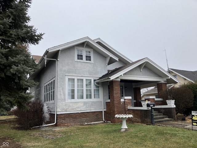 view of front of house with a front yard and a porch