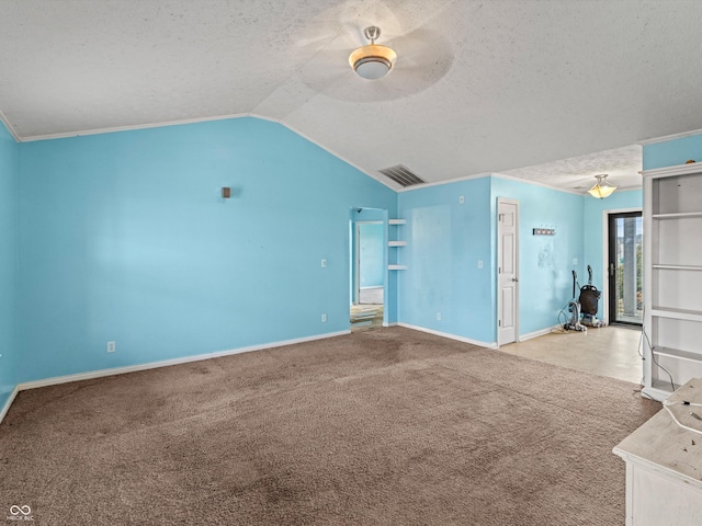 unfurnished living room with baseboards, visible vents, lofted ceiling, a textured ceiling, and carpet floors