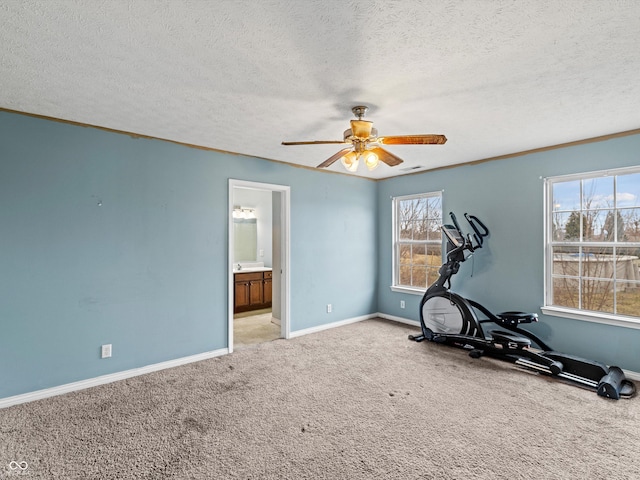 workout area with light carpet, a textured ceiling, a ceiling fan, and baseboards