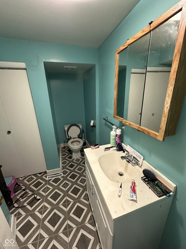 bathroom featuring vanity and toilet