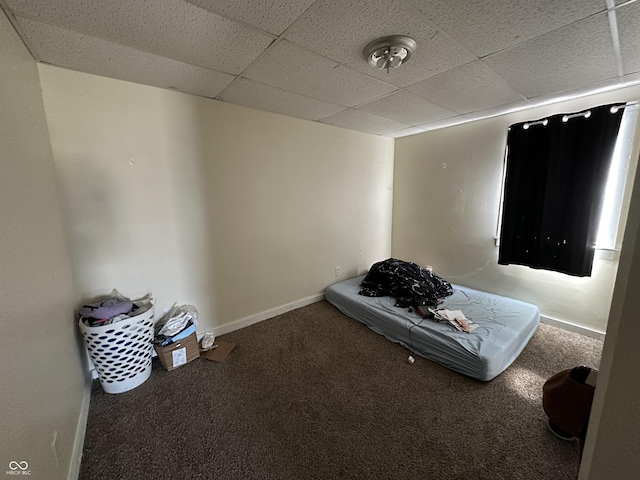 unfurnished bedroom featuring carpet flooring and a drop ceiling