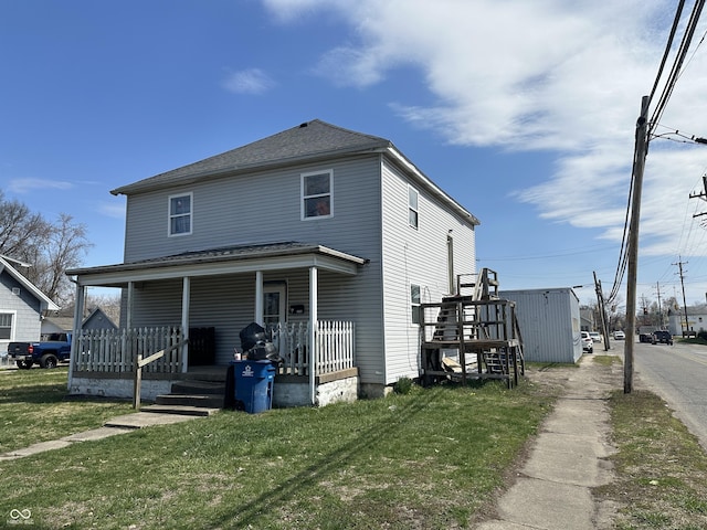 exterior space featuring a yard and covered porch