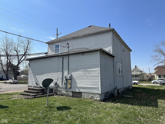 view of side of home featuring a yard