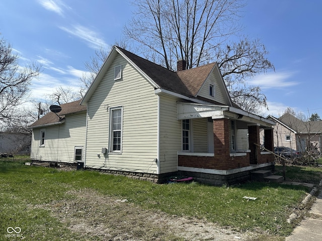 view of side of property with a lawn