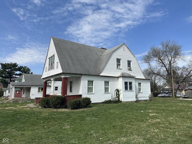 view of front of house with a porch and a front yard