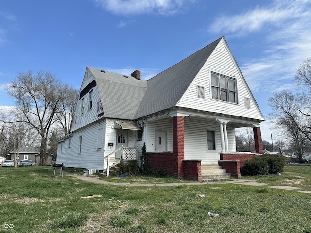 view of property exterior featuring a yard and covered porch