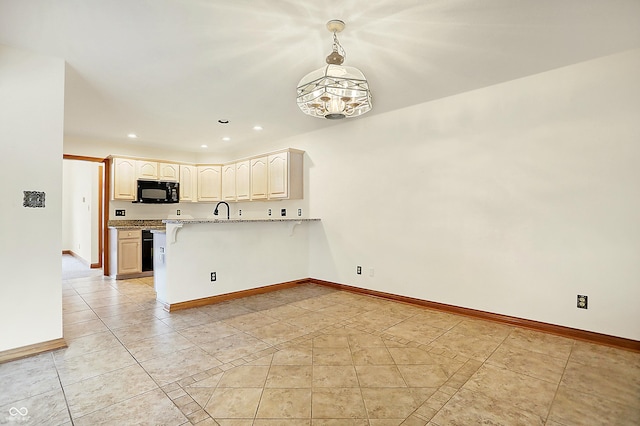 kitchen with pendant lighting, sink, light tile patterned floors, kitchen peninsula, and light stone countertops