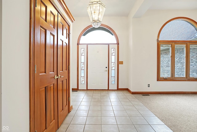 entryway featuring light colored carpet