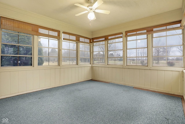 unfurnished sunroom with a wealth of natural light and ceiling fan