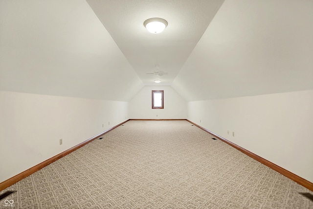 bonus room with carpet floors and vaulted ceiling