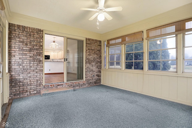 unfurnished sunroom with ceiling fan