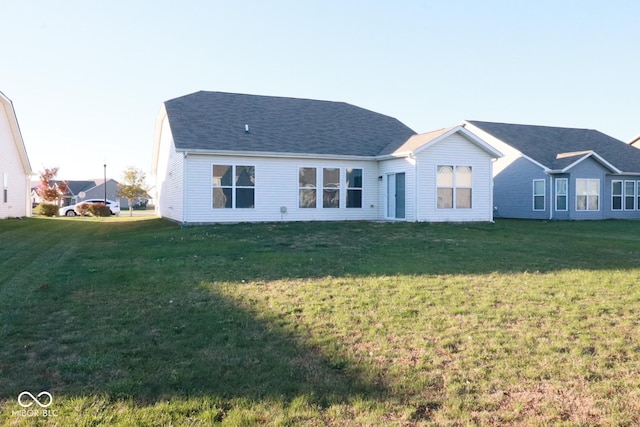 back of property featuring a lawn