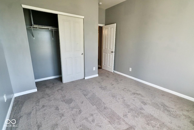 unfurnished bedroom featuring carpet and a closet