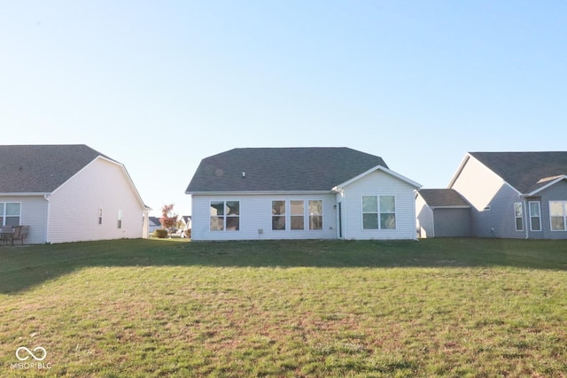 rear view of property with a lawn