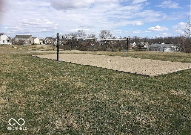 view of property's community featuring a yard and volleyball court