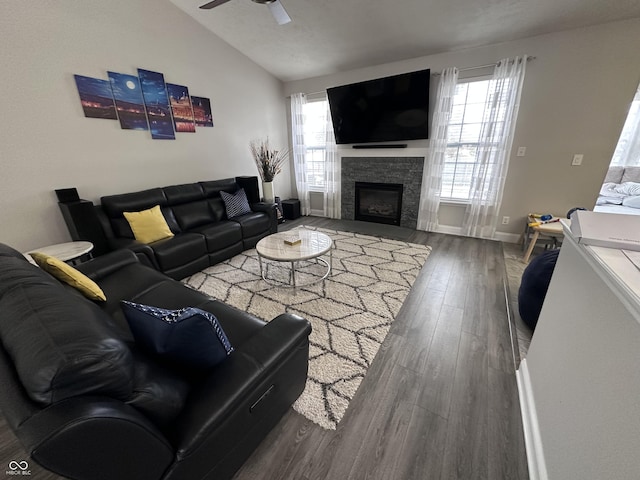 living room featuring dark hardwood / wood-style flooring, vaulted ceiling, and ceiling fan